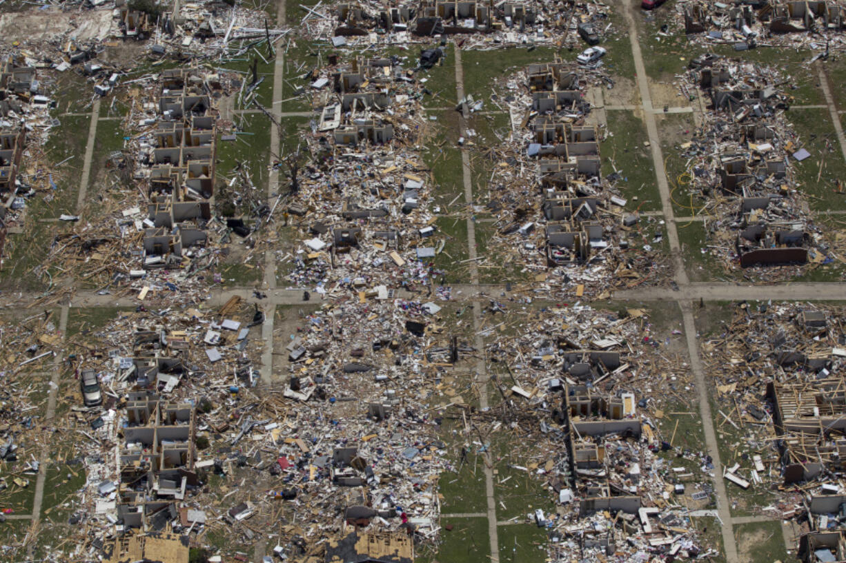 FILE - Debris covers the ground in the aftermath of a tornado in Tuscaloosa, Ala., May 7, 2011. Meteorologists are warning of a series of severe storms that could rip across America's Midwest and South over the next couple of weeks. One weather expert said the current persistent pattern of storm ingredients is consistent with the April 2011 tornado onslaught, one of the largest, deadliest and most destructive tornado outbreaks in American history.