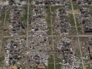 FILE - Debris covers the ground in the aftermath of a tornado in Tuscaloosa, Ala., May 7, 2011. Meteorologists are warning of a series of severe storms that could rip across America's Midwest and South over the next couple of weeks. One weather expert said the current persistent pattern of storm ingredients is consistent with the April 2011 tornado onslaught, one of the largest, deadliest and most destructive tornado outbreaks in American history.