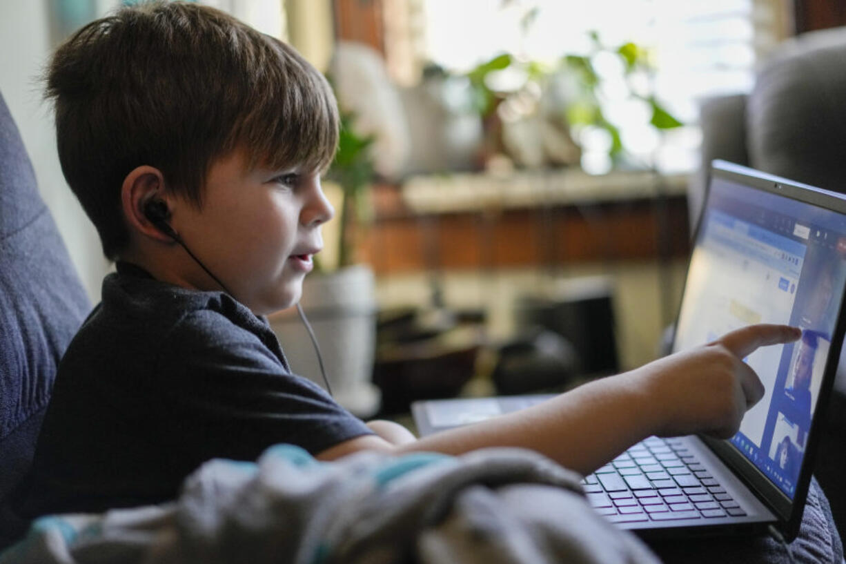 Phoenix Blalack, 6, works with a tutor on his laptop Tuesday in his Indianapolis home. (A.J.