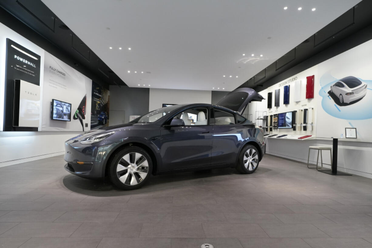 FILE - A Tesla Model Y Long Range is displayed on Feb. 24, 2021, at the Tesla Gallery in Troy, Mich. U.S. auto safety regulators have opened an investigation into Tesla's Model Y SUV after getting two complaints that the steering wheels can come off while being driven. The National Highway Traffic Safety Administration says the probe covers an estimated 120,000 vehicles from the 2023 model year.