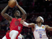 Portland Trail Blazers forward Nassir Little, left, looks to shoot over Oklahoma City Thunder guard Shai Gilgeous-Alexander during the second half of an NBA basketball game in Portland, Ore., Sunday, March 26, 2023.