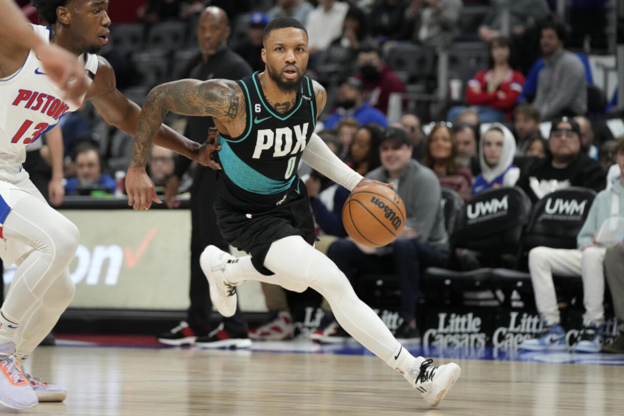 Portland Trail Blazers guard Damian Lillard brings the ball up court during the first half of an NBA basketball game against the Detroit Pistons, Monday, March 6, 2023, in Detroit.