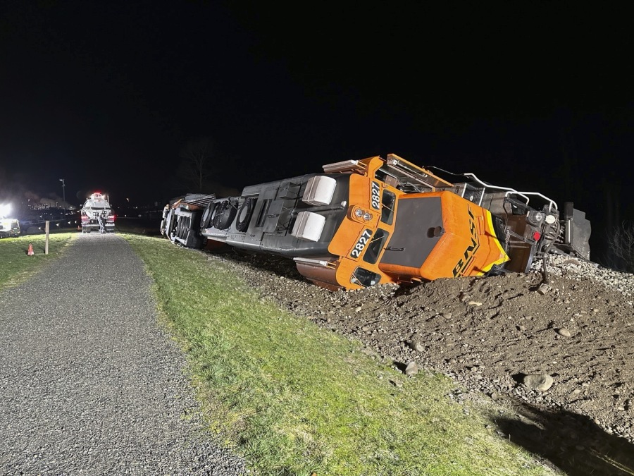 A derailed BNSF train is seen Thursday on a berm along Puget Sound on the Swinomish tribal reservation near Anacortes. There were no injuries but 5,000 gallons of diesel fuel was spilled.