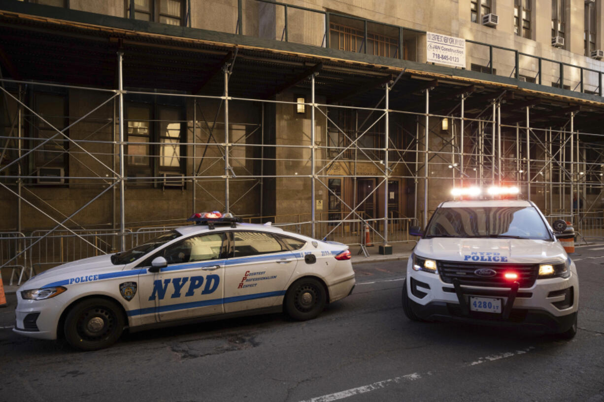 NYPD vehicles parked outside District Attorney's office in New York, Wednesday, March. 29, 2023.  The Manhattan grand jury investigating former President Donald Trump over hush money payments has returned to hear more evidence, with still no word on when it might be asked to vote on a possible indictment.