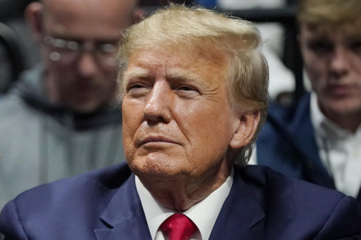 FILE - Former President Donald J. Trump watches the NCAA Wrestling Championships, Saturday, March 18, 2023, in Tulsa, Okla. Trump's calls for protests ahead of his anticipated indictment in New York have generated mostly muted reactions from supporters, with even some of his most ardent loyalists dismissing the idea as a waste of time or a law enforcement trap.