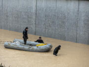 Rescue team members carry the body of a person in a rubber boat during floods after heavy rains in Sanliurfa, Turkey, Wednesday, March 15, 2023. Floods caused by torrential rains hit two provinces that were devastated by last month's earthquake, killing at least 10 people and increasing the misery for thousands who were left homeless, officials and media reports said Wednesday. At least five other people were reported missing.