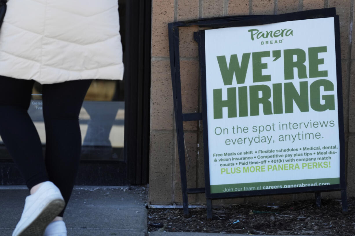 A hiring sign is displayed at a restaurant in Mount Prospect, Ill., Sunday, March 19, 2023. On Thursday, the Labor Department reports on the number of people who applied for unemployment benefits last week. (AP Photo/Nam Y.
