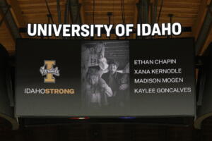 A photo and the names of four University of Idaho students who were killed in November at a residence near campus are displayed during a moment of silence, Nov. 16, 2022, before an NCAA college basketball game in Moscow, Idaho. Idaho lawmakers this week approved transferring $1 million to the University of Idaho to help the school cover the expenses associated with the killings. (AP Photo/Ted S.