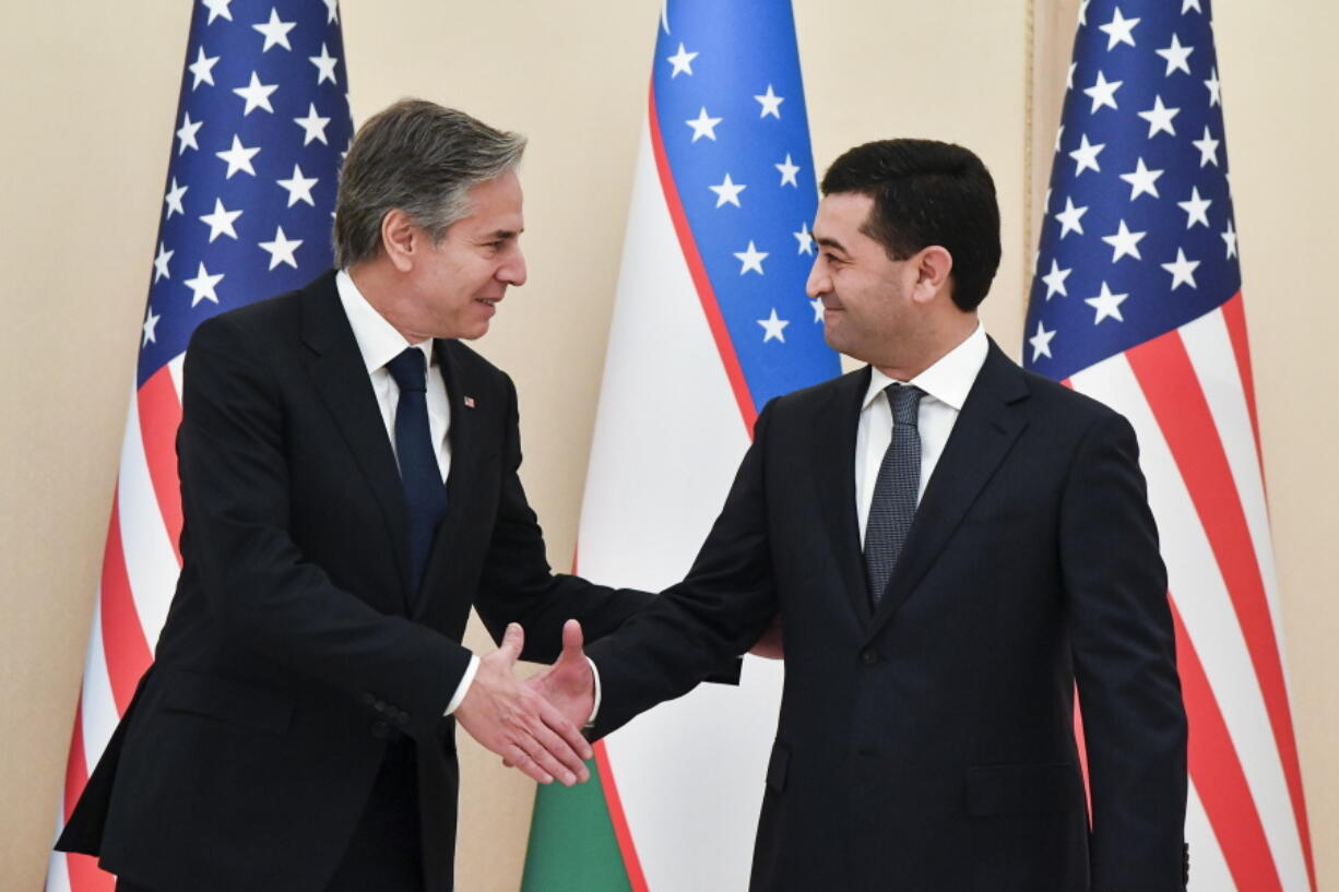 U.S. Secretary of State Antony Blinken, left, shakes hands with Uzbekistan Acting Foreign Minister Bakhtiyor Saidov during their meeting at the National Library in Tashkent, Uzbekistan, Wednesday, March 1, 2023.