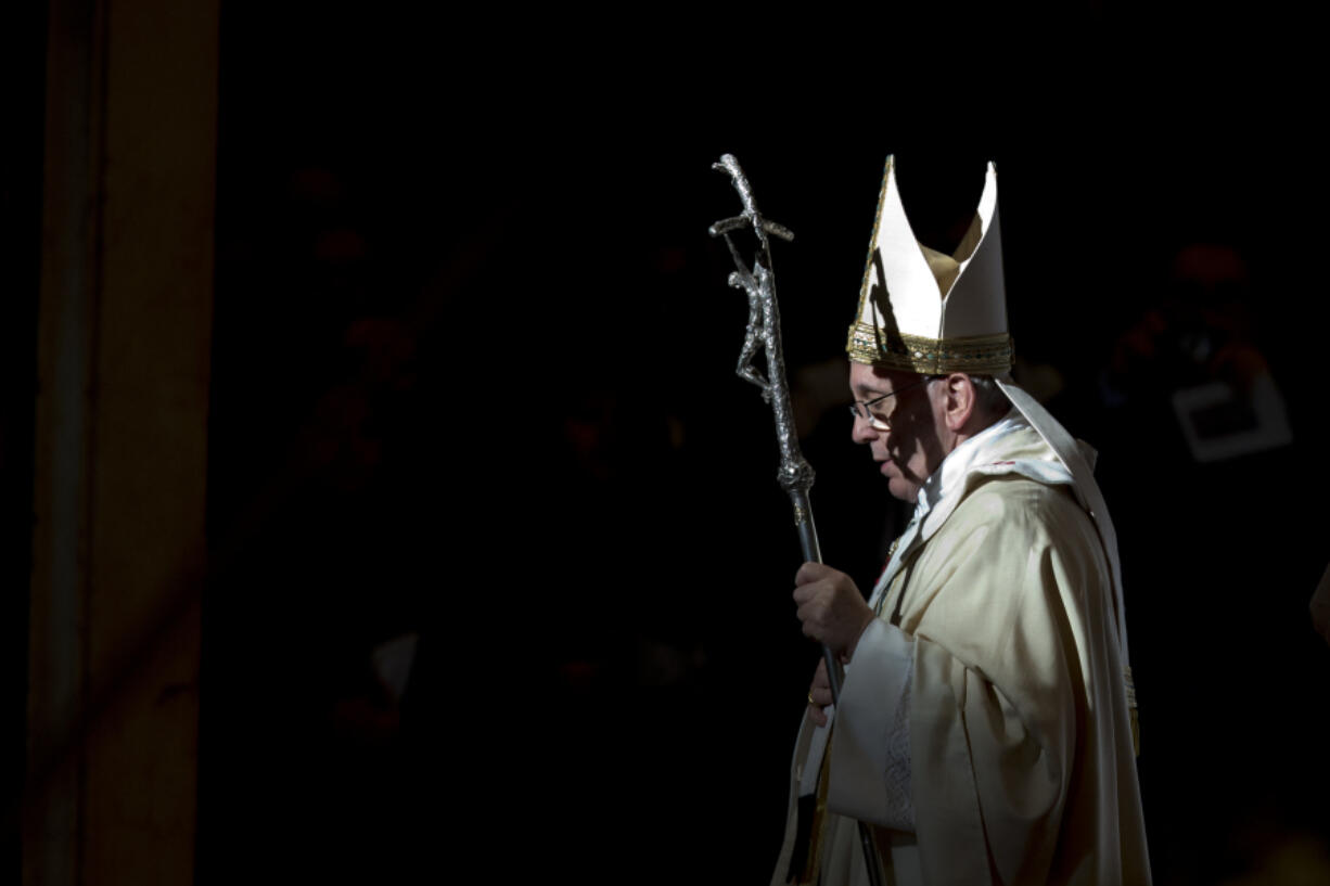 FILE - Pope Francis holds the pastoral staff as he leaves after celebrating a Mass in St. Peter's Basilica, at the Vatican, to mark Epiphany, Jan. 6, 2014. Pope Francis celebrates the 10th anniversary of his election Monday, March 13, 2023, far outpacing the "two or three" years he once envisioned for his papacy and showing no signs of slowing down.