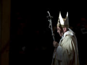 FILE - Pope Francis holds the pastoral staff as he leaves after celebrating a Mass in St. Peter's Basilica, at the Vatican, to mark Epiphany, Jan. 6, 2014. Pope Francis celebrates the 10th anniversary of his election Monday, March 13, 2023, far outpacing the "two or three" years he once envisioned for his papacy and showing no signs of slowing down.