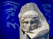 The marble head of a young man, a tiny fragment from the 2,500-year-old sculptured decoration of the Parthenon Temple on the ancient Acropolis, is displayed in 2008 during a presentation to the press at the new Acropolis Museum in Athens.