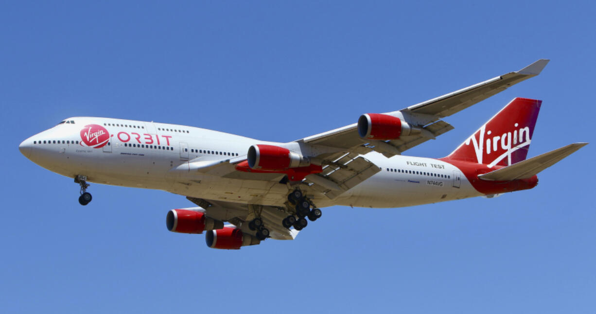 FILE - A Virgin Orbit Boeing 747-400 aircraft named Cosmic Girl prepares to land back at Mojave Air and Space Port in the desert north of Los Angeles Monday, May 25, 2020.  Richard Branson's Virgin Orbit is slashing 85% of its workforce, Friday, March 31, 2023,  after running into problems with funding less than four months after a mission of the satellite launching company failed.