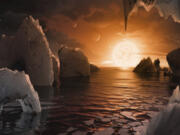 This image provided by NASA/JPL-Caltech shows an artist's conception of what the surface of the exoplanet TRAPPIST-1f may look like, based on available data about its diameter, mass and distances from the host star. The Webb Space Telescope has found no evidence of an atmosphere at one of the seven rocky, Earth-size worlds orbiting a nearby star. Scientists say that doesn't bode well for the rest of the planets in this solar system, some of which are in the sweet spot for harboring water and, therefore, life. In a study published Monday, March 27, 2023 a NASA-led team reported little if no atmosphere exists at the innermost planet in the Trappist system, 40 light-years away.