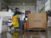 A worker moves fish into a freezer at Costarella Seafoods on Pier 45 in San Francisco, Monday, March 20, 2023. On April 7, the Pacific Fishery Management Council, the regulatory group that advises federal officials, will take action on what to do about the 2023 season for both commercial and recreational salmon fishing. (AP Photo/Godofredo A.