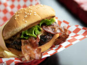 Nick???s Jr.???s peanut butter bacon burger glistens in the light on Friday, March 31, 2023, at the restaurant in Everett, Washington.