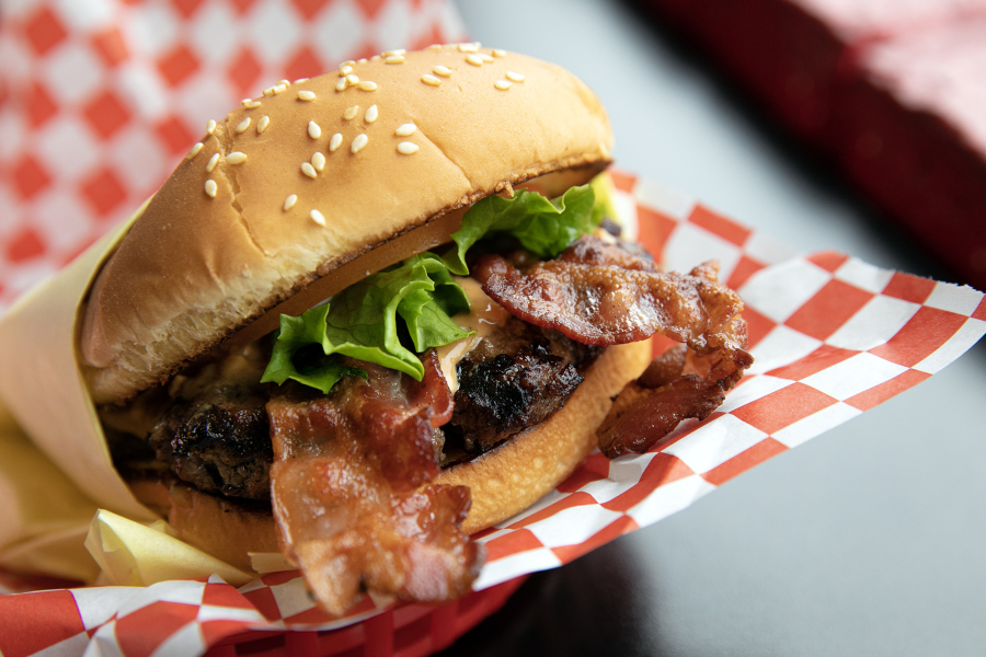 Nick???s Jr.???s peanut butter bacon burger glistens in the light on Friday, March 31, 2023, at the restaurant in Everett, Washington.