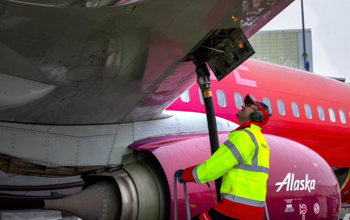 Fueling agent Amer Halilovic keeps his eyes on gauges as he refuels an Alaska Airlines jet at Sea-Tac Airport. (Ellen M.