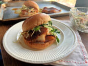 Spicy cod sandwich on a brioche bun with a lime slaw.