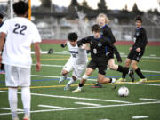 Heritage’s Pablo Barbosa-Sanchez (10) and Mountain View’s Emin Music (8) battle for possession of the ball during a 3A Greater St. Helens League boys soccer game on Tuesday, April 11, 2023, at Mountain View High School.