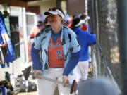 Maizy Whitlow holds a toy barbell in the dugout after hitting a first-inning home run during Ridgefield's 19-6 win over Columbia River in a 2A Greater St. Helens League softball game at VGSA on Thursday, April 13, 2023.