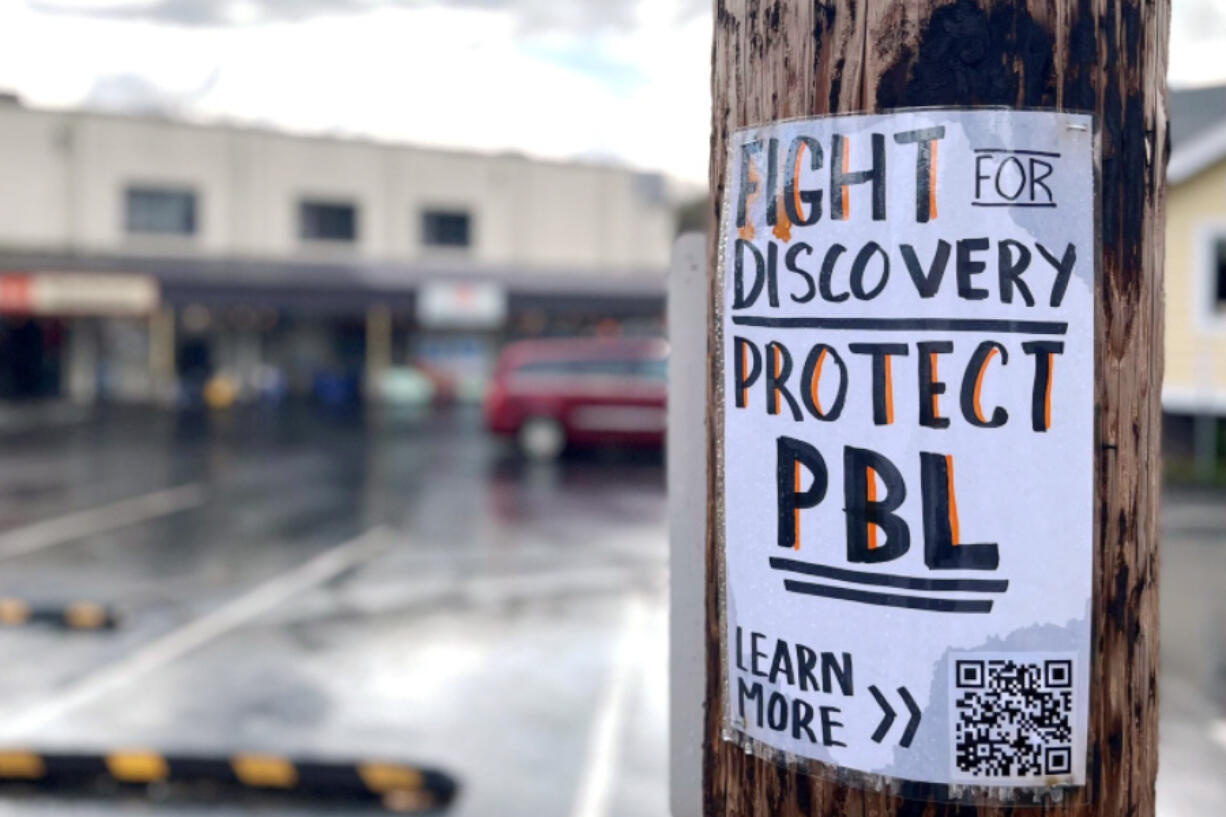 A sign asking the community to "Fight for Discovery" hangs April 7 in downtown Camas.
