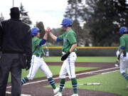 Mountain View’s Jett Hamilton and Jacob Martin embrace at home plate after each scored runs in the first inning of a 3A Greater St. Helens League baseball game against Evergreen on Tuesday, April 18, 2023, at Evergreen High School.