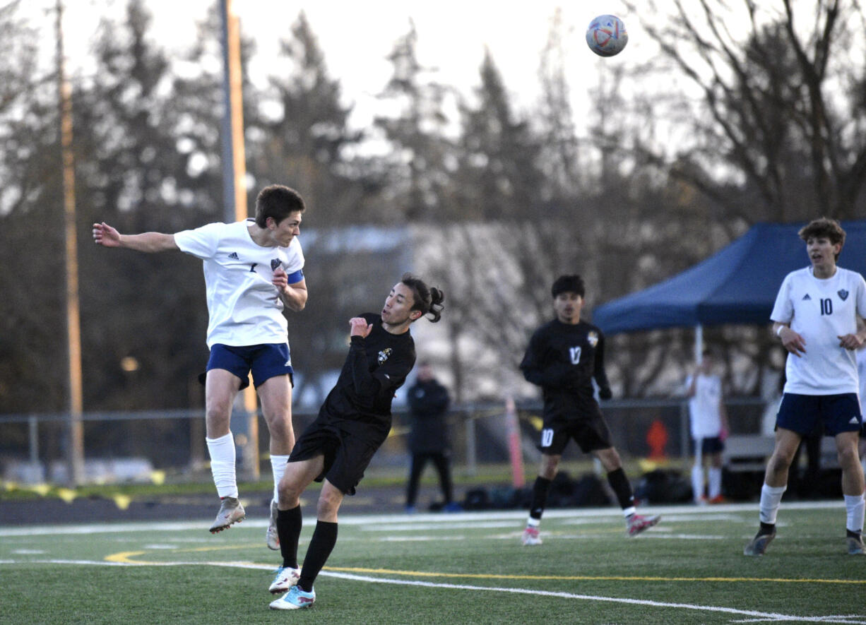 Hockinson’s Tristan Maldonado, left, leaps to head a ball toward a teammate in a 2A Greater St. Helens League boys soccer game against Hudson’s Bay on Wednesday, April 19, 2023, at Hudson’s Bay High School.