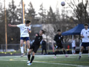 Hockinson’s Tristan Maldonado, left, leaps to head a ball toward a teammate in a 2A Greater St. Helens League boys soccer game against Hudson’s Bay on Wednesday, April 19, 2023, at Hudson’s Bay High School.