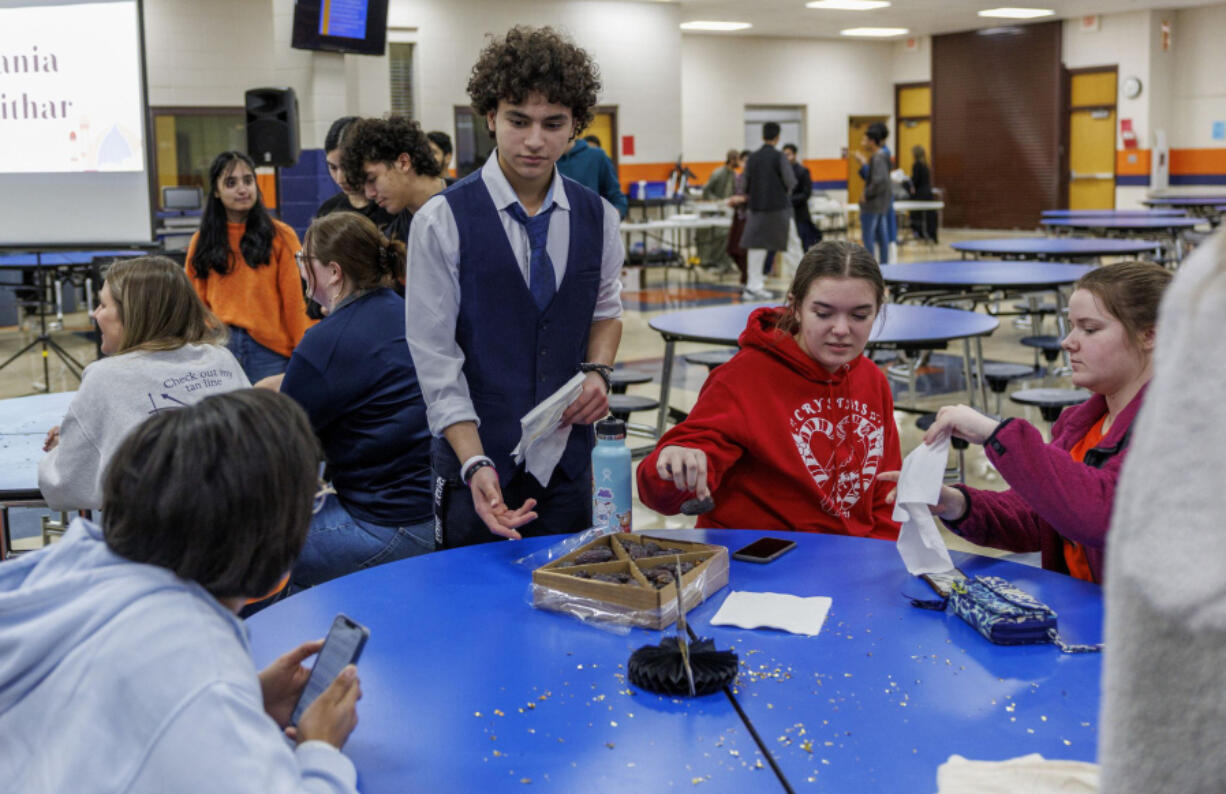 Abdullah Abouhaiba, 15, passes out dates during an iftar Ramadan dinner fast-a-thon at Oswego High School, Apr. 5, 2023, in Oswego. During the day, Muslim students from Oswego High School invited non-Muslim students to join their fast for the day and participate in an iftar, breaking of the fast meal. (Armando L. Sanchez/Chicago Tribune/TNS) (Armando L.