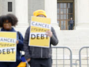 A police officer watches as student loan borrowers and advocates gather for the People's Rally to Cancel Student Debt during Supreme Court hearings on student debt relief, on Feb. 28, 2023, in Washington, D.C. Student loan relief scams are as prevalent as ever due to the ever-evolving status of loans at the federal level.