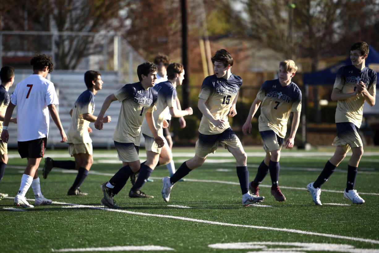 Seton Catholic’s Sam Soto (1) celebrates with teammates after scoring one of his three first-half goals during a Trico League boys soccer game on Tuesday, April 25, 2023, at Seton Catholic High School.