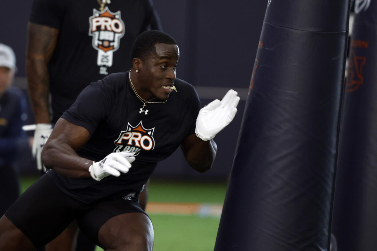 Auburn linebacker Derick Hall performs a drill as NFL scouts watch during Auburn Pro Day, Tuesday, March 21, 2023, in Auburn, Ala.