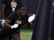 Auburn linebacker Derick Hall performs a drill as NFL scouts watch during Auburn Pro Day, Tuesday, March 21, 2023, in Auburn, Ala.