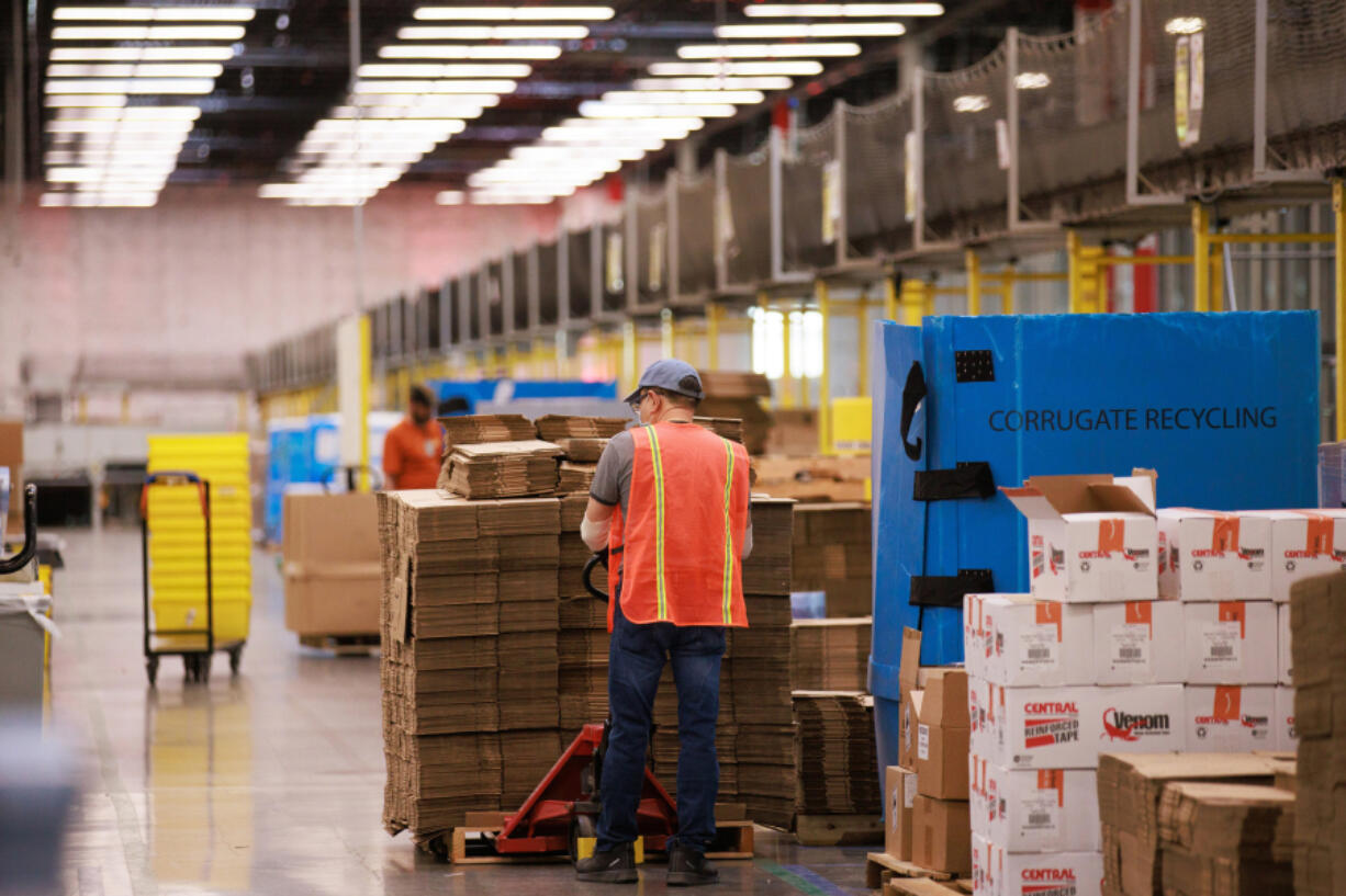 Amazon employees work inside Amazon's Kent fulfillment center in Kent, Washington, Friday, July 22, 2022.