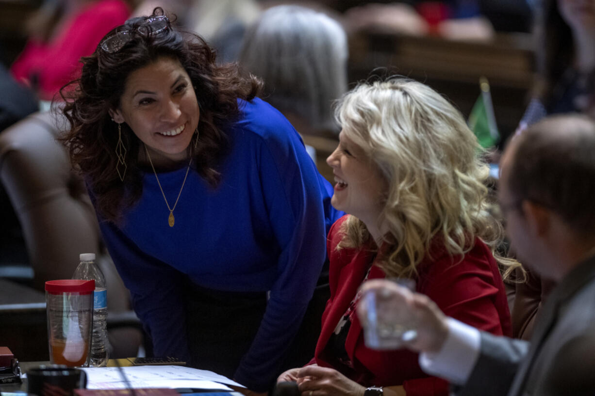 Majority Floor Leader Rep. Monica Stonier, D-Vancouver, left, talks with Minority Floor Leader, Republican Rep. Jacquelin Maycumber, center, and Republican Rep. Morgan Irwin, right, during a previous session in Olympia.