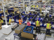 Workers assemble products and packaging in the manufacturing department at Hawthorne Gardening Co. in 2021. The company, which announced two layoffs at its Vancouver operation last year, recently reported a 31 percent loss in net sales.