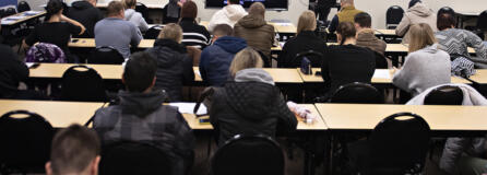 Ukrainian refugees take in a job-hunt orientation session at Partners in Careers in Vancouver. Recent Ukrainian refugee and PIC employment specialist Sasha Cheban, left, translates into Ukrainian while employment specialist Kegan Gibson, right, gives a talk in English about resumes and cover letters.