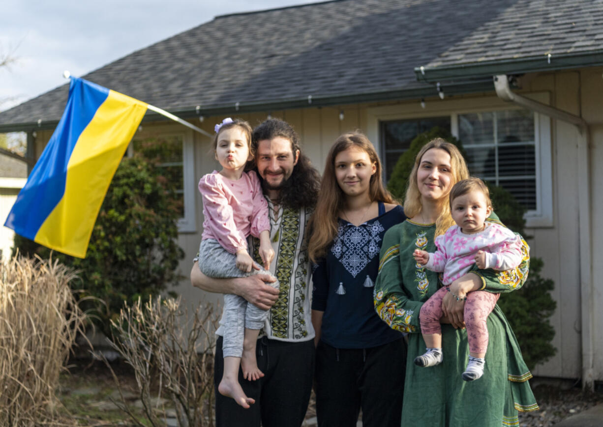 Diana Hornishevska, 4, from left, Yevhenii Hornishevskyi, Sofia Hornishevska, 10, Alona Hornishevska and Miroslava Hornishevska, 1, stand outside their house. The family has found community in Vancouver after escaping war in Ukraine in February 2023.