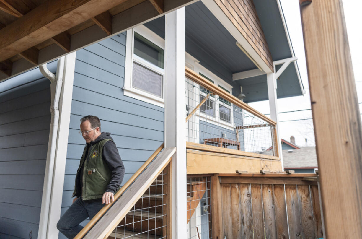 Jerrad Isch walks down the exterior stairs of his Airbnb in Vancouver. He been renting out the unit for about five years and says that it has been a largely positive experience for him and his neighbors.