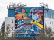 Portland-based artist Christian T?llez works on a mural Tuesday at the Fourth Plain Community Commons building. The mural is called "Step Up" and is credited to the Portland Street Art Alliance, fellow local muralist Alex Chiu and T?llez, according to a city of Vancouver Instagram post.