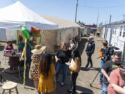 People enjoy the sunshine Friday, April 28, 2023, during a celebration of the 1-year anniversary of the Hope Village Safe Stay community on Fourth Plain Boulevard.