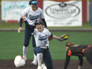 Skyview junior Jenna Stockton, center, celebrates after tagging out a Battle Ground runner Wednesday, April 12, 2023, during the Storm’s 4-0 win against Battle Ground at Fort Vancouver High School.