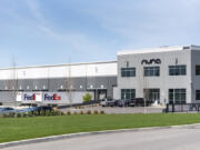 FedEx and UPS trucks sit at loading bays at an Aurora Logistics warehouse in Vancouver. The city enacted a moratorium on large new warehouses at the end of last year.