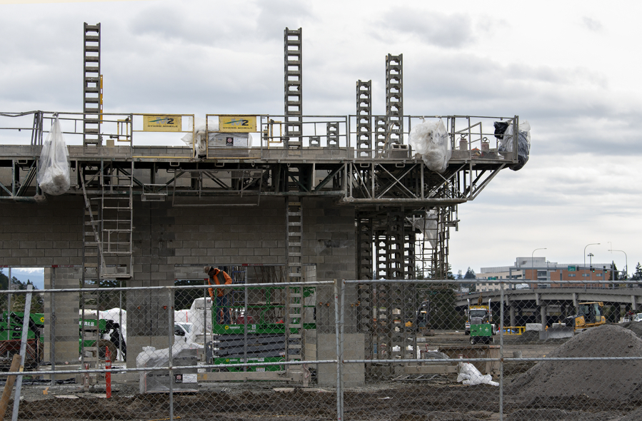 Motorists pass by construction as it continues on the new Skyview Station in Salmon Creek on Monday morning. Skyview Station, a project of Vancouver-based Hurley Development, will open at the intersection of Northeast 10th Avenue and 139th Street.