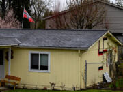 La Center residents want the city council to do something about the hand-painted swastikas and Nazi-themed flag decorating their neighbor's home.