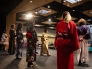 Members of the Clark College Japanese Club greet the audience while taking part in a fashion show during the annual Sakura Festival on Thursday afternoon. More than 30 years ago, the city of Vancouver received a gift of friendship: 100 Shirofugen cherry trees, commemorating the 100th Anniversary of Washington's statehood.