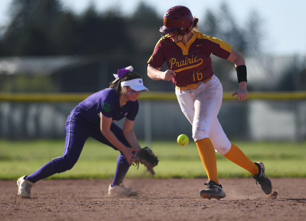 Prairie freshman Mackenzie Moore, right, dashes to third base Thursday, April 27, 2023, during the Falcons’ 2-1 win against Heritage at Prairie High School.