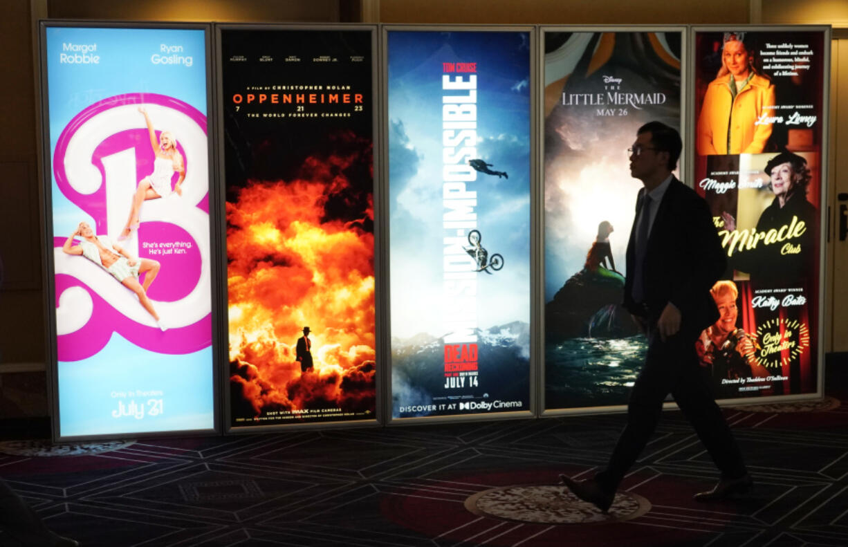 An attendee walks past advertisements for upcoming films on the opening day of CinemaCon 2023, the official convention of the National Association of Theatre Owners (NATO) at Caesars Palace, Monday, April 24, 2023, in Las Vegas. The four-day convention runs through Thursday.