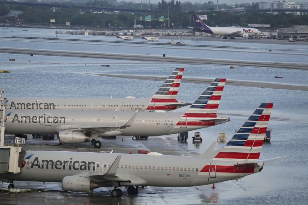 Airplanes sit on the runway due to flooding at Fort Lauderdale Hollywood airport Thursday, April 13, 2023 in Fort Lauderdale, Fla.  Nearly a foot of rain fell in a matter of hours in Fort Lauderdale - causing widespread flooding, the closure of the city's airport, all public schools and the suspension of high-speed commuter rail service.